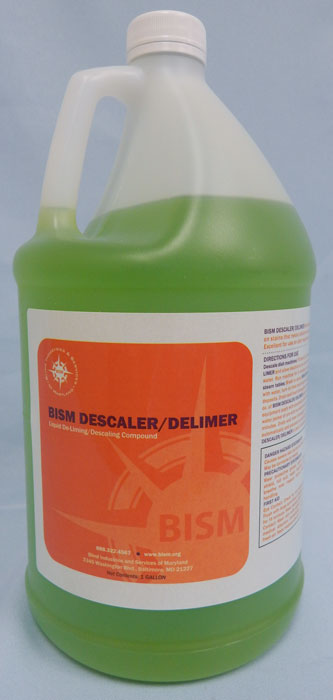 clear jug with green liquid inside, orange label - BISM DESCALER/DELIMER